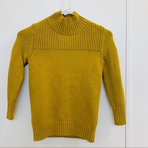 A cute turtle neck sweater.